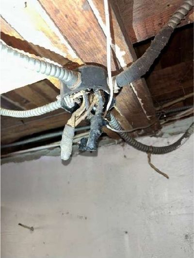 Open junction box with exposed splices and old branch wiring on the basement ceiling of a pre-war Willow Grove PA home, found during a July 2026 home inspection