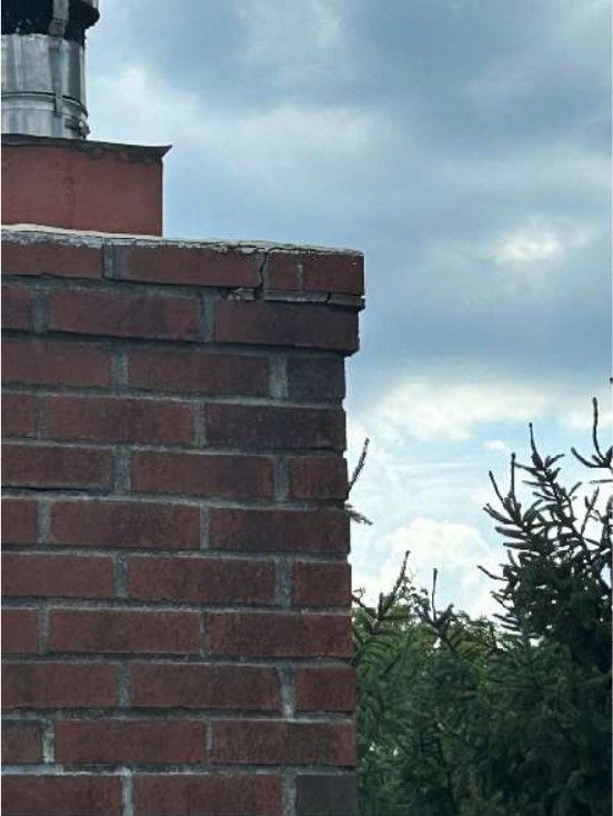 Deteriorated mortar joints between chimney bricks on a Yardley, PA home documented during a home inspection, showing eroded masonry