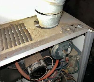 Unsecured gas furnace flue vent connector sharing a chimney flue in a Northern Liberties Philadelphia storefront basement, found during a May 2026 home inspection