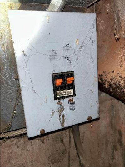 Undersized 60-amp double-pole main electrical panel with cobwebs in a Northern Liberties Philadelphia mixed-use storefront, found during a May 2026 home inspection