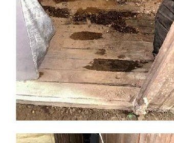 Active water infiltration staining a stone foundation wall in a Germantown, PA row-home basement during a home inspection