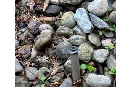 Pool deck coping area with unsecured rock bed and missing tie-downs at waterfall feature — Schwenksville PA home inspection June 2026
