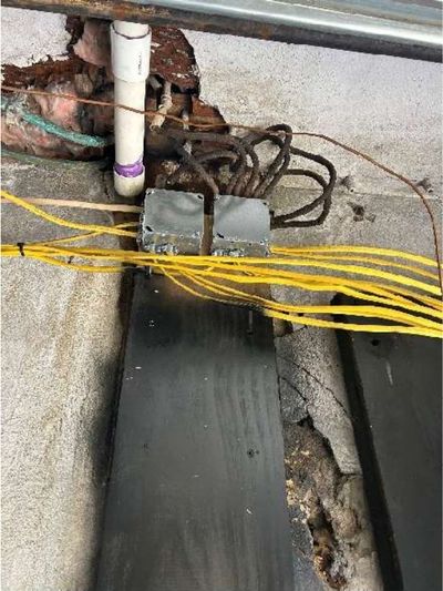 Active knob-and-tube wiring in the garage of a 1945 Logan / Fern Rock rowhome in North Philadelphia, found during a June 2026 home inspection