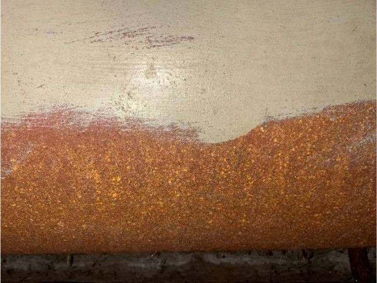 Corroded oil tank bottom showing leak risk in the basement of a Phoenixville, PA home, recorded during a home inspection