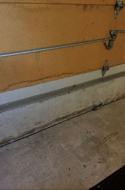 Water staining and discoloration along the base of a garage wall in a West Chester PA home, documented during a June 2026 mold test