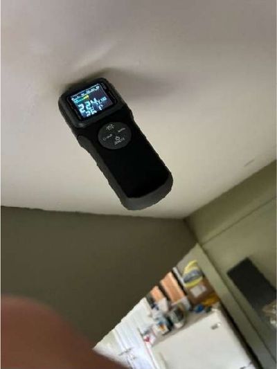 Moisture meter reading wet on a stained garage ceiling in a Yardley PA home, indicating active water intrusion during a June 2026 home inspection