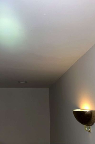 Water staining on an interior ceiling near a wall sconce in a West Chester PA home, part of the moisture evidence documented during a June 2026 mold test