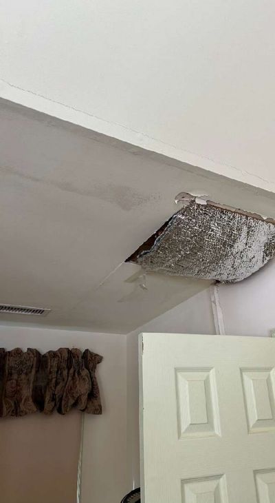 Failed ceiling section with peeling paint exposing insulation from past water leaks in a Kennett Square PA home, documented during a December 2025 mold test
