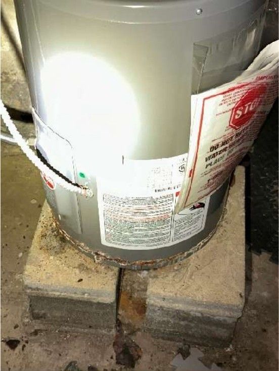 Corroded water heater with signs of leaking in a Northern Liberties, PA home basement, photographed during a home inspection