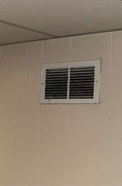 Wall-mounted HVAC return register on paneling in an Ardmore PA finished basement, swabbed during a June 2026 mold test