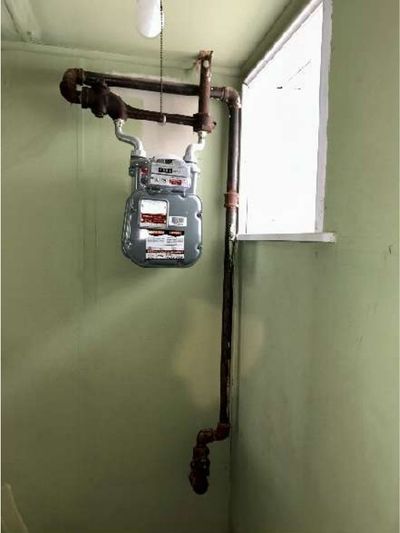 Basement gas meter and copper gas piping at 7015 Large St Northeast Philadelphia, near where a strong gas odor was found during a May 2026 home inspection
