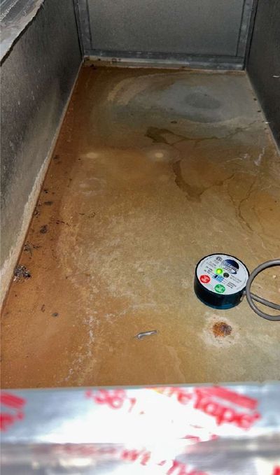 Water-stained closet floor with a moisture meter in a Silverdale, Bucks County PA commercial office, documented during a May 2026 mold test