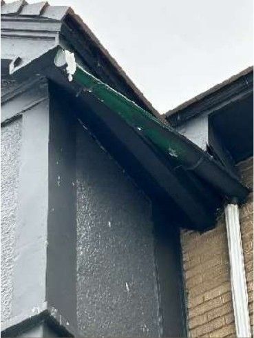 Brick chimney with open and deteriorated mortar joints above a clay tile roof on a Fern Rock Philadelphia rowhome, documented during a home inspection