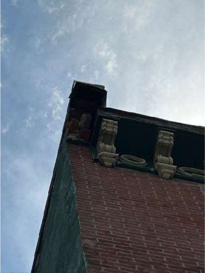Deteriorated front cornice and soffit with missing capping on a circa-1900 Fishtown Philadelphia mixed-use rowhome, documented during a May 2026 home inspection