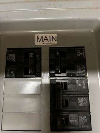 Electrical panel labeled MAIN showing two separate 100-amp main breakers instead of a single 200-amp service in a Germantown Philadelphia row home, photographed during a May 2026 home inspection