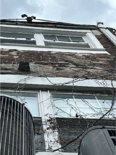 Deteriorated and shifted brick with open, spalling joints on the wall of a Fishtown Philadelphia mixed-use rowhome, found during a May 2026 home inspection