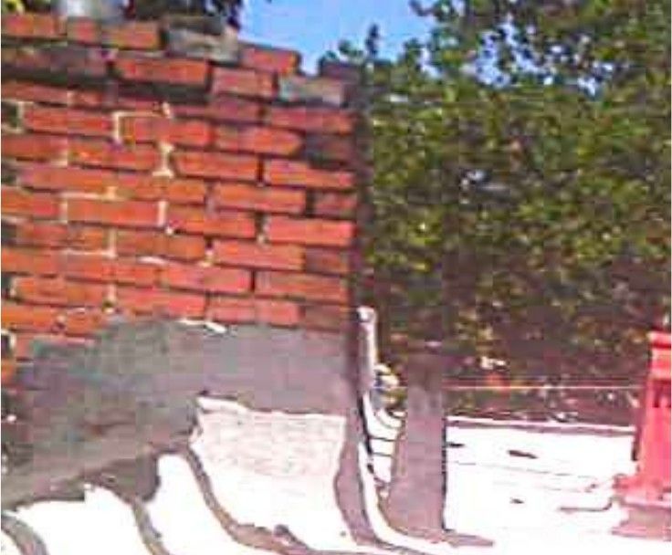 Damaged masonry chimney with no flue liner at a Logan, Philadelphia, PA home found during a home inspection, an unlined venting hazard