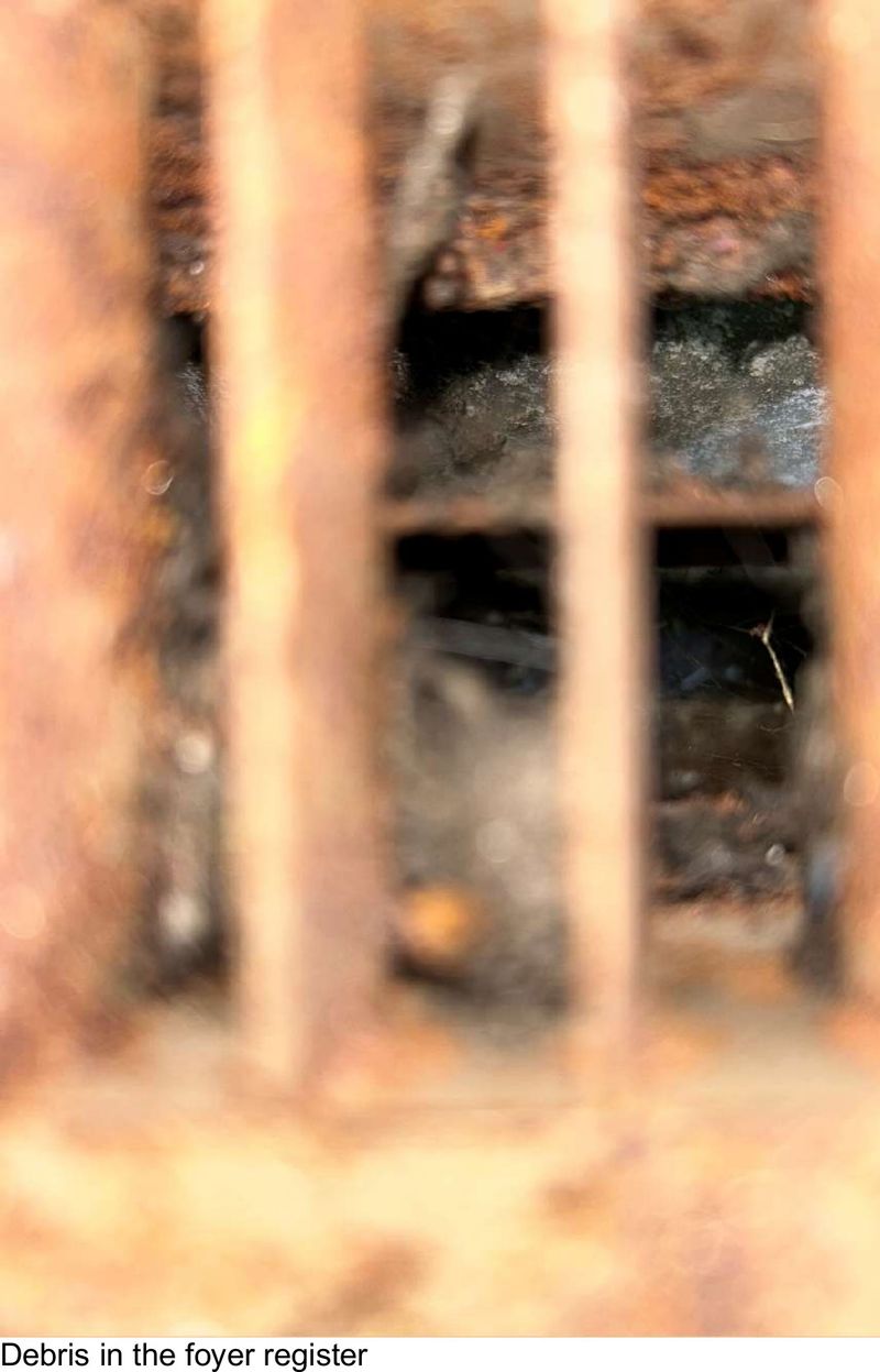 Debris inside an HVAC foyer floor register in a West Chester, PA home during a home inspection
