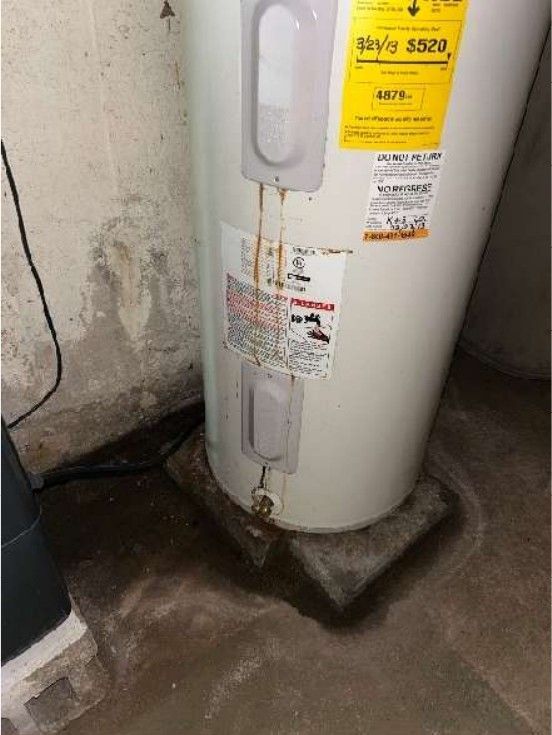 Leaking water heater with corrosion and moisture at the base in a Phoenixville, PA home, found during a home inspection