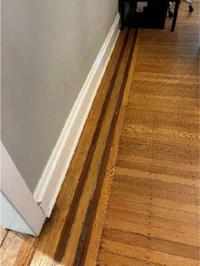Excessive settlement and a gap between the hardwood dining room floor and baseboard in a 1940s Roxborough Philadelphia home, found during a June 2026 home inspection