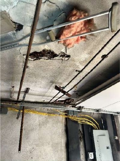 Holes in the garage ceiling compromising the fire barrier in a Logan / Fern Rock North Philadelphia rowhome, found during a June 2026 home inspection