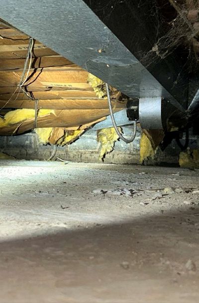 HVAC ductwork suspended between crawl space joists next to sagging insulation in an Ambler PA home